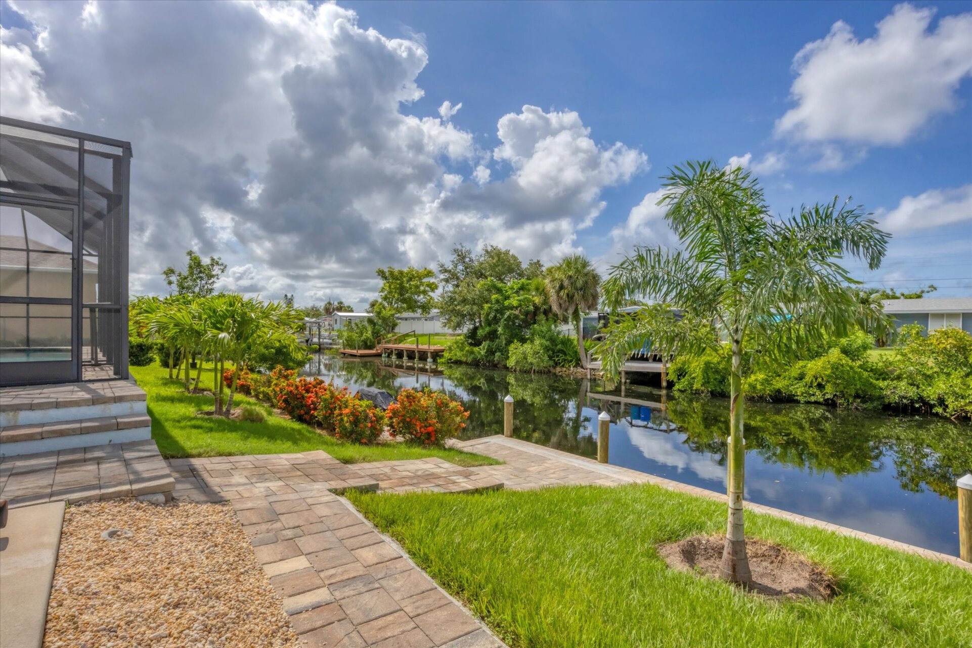 Backyard with path leading to boat dock and canal