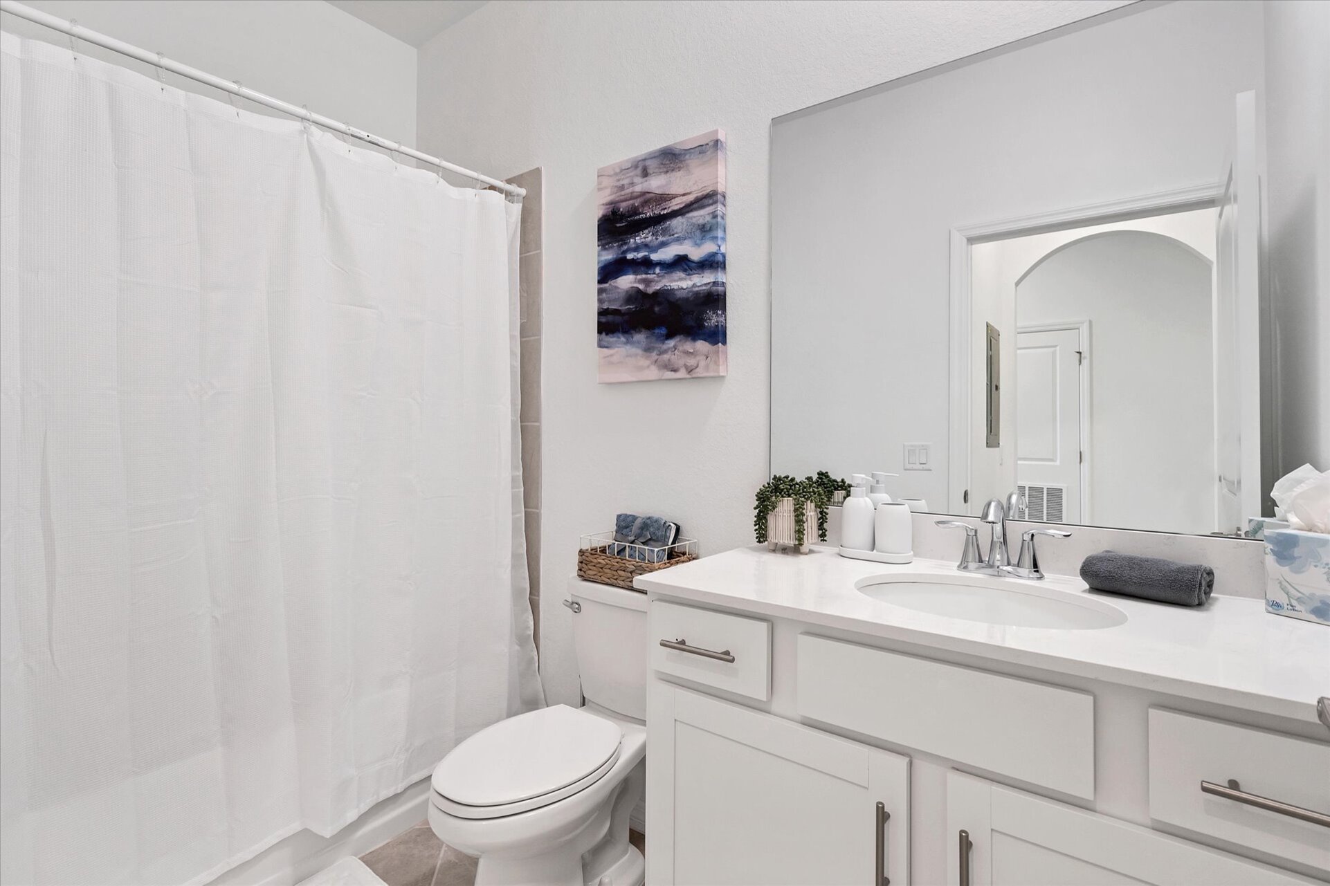The guest bathroom has a shower/tub combo
