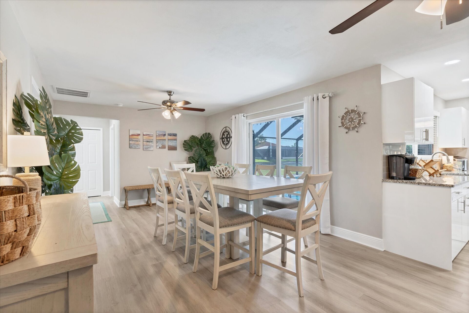 Dining room with additional refrigerator and lanai aceess. Dining table seats 8