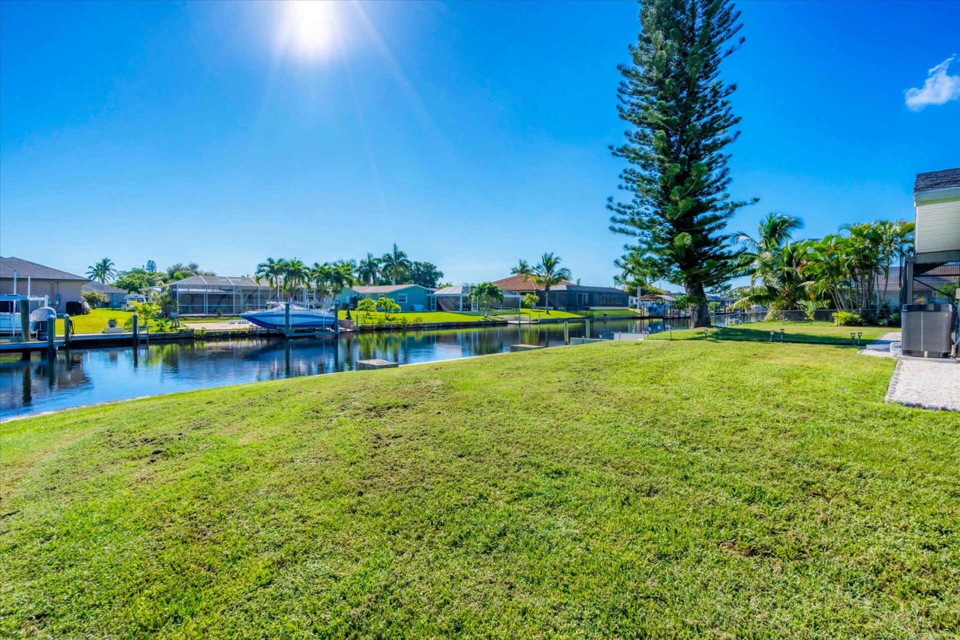 Large backyard leading to dock and canal
