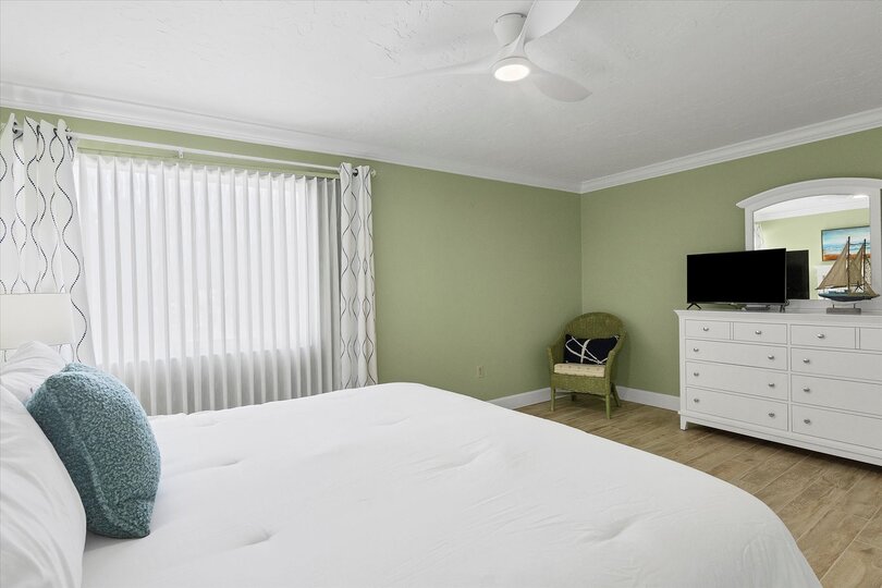 Primary bedroom with king bed and 32-inch Smart TV