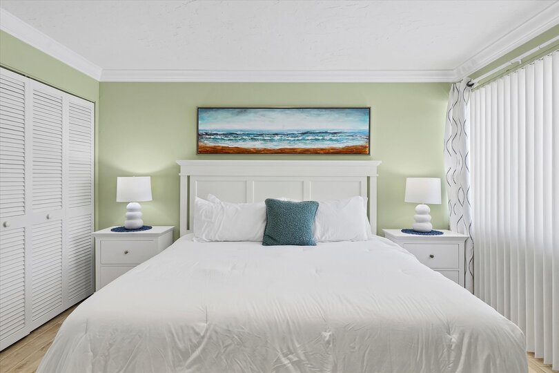 Primary bedroom featuring king bed and 32-inch Smart TV