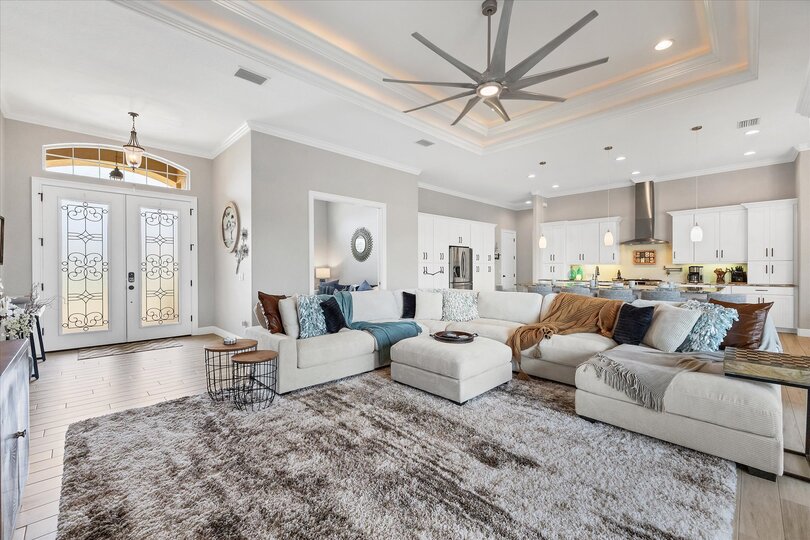 Gorgeous, open living space overlooking private pool, canal, and nature preserve beyond. Living room features lots of comfy seating and 70-inch Smart TV