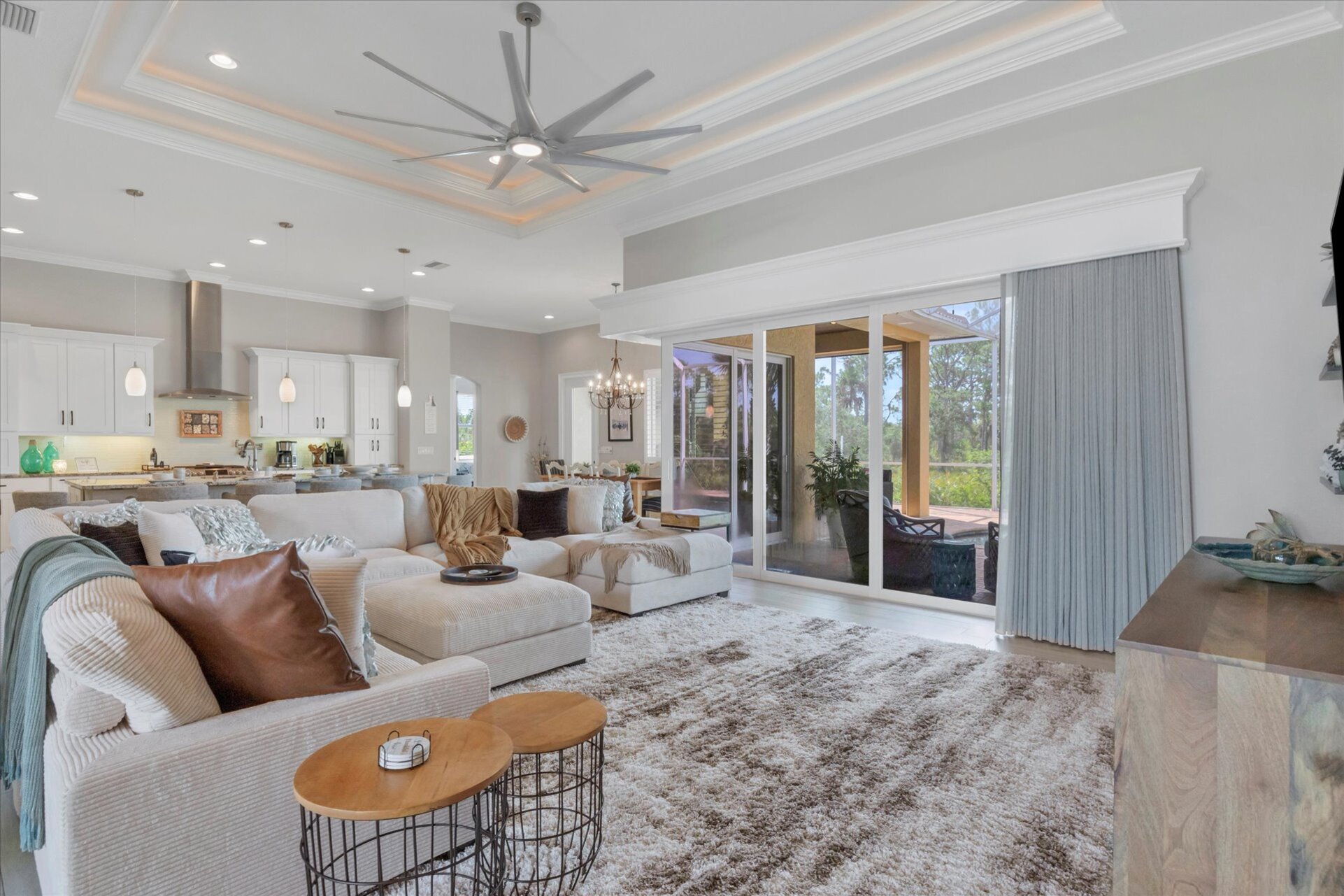 Gorgeous, open living space overlooking private pool, canal, and nature preserve beyond. Living room features lots of comfy seating and 70-inch Smart TV