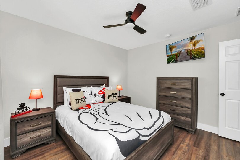 Upstairs bedroom with comfortable queen bed and personal TV