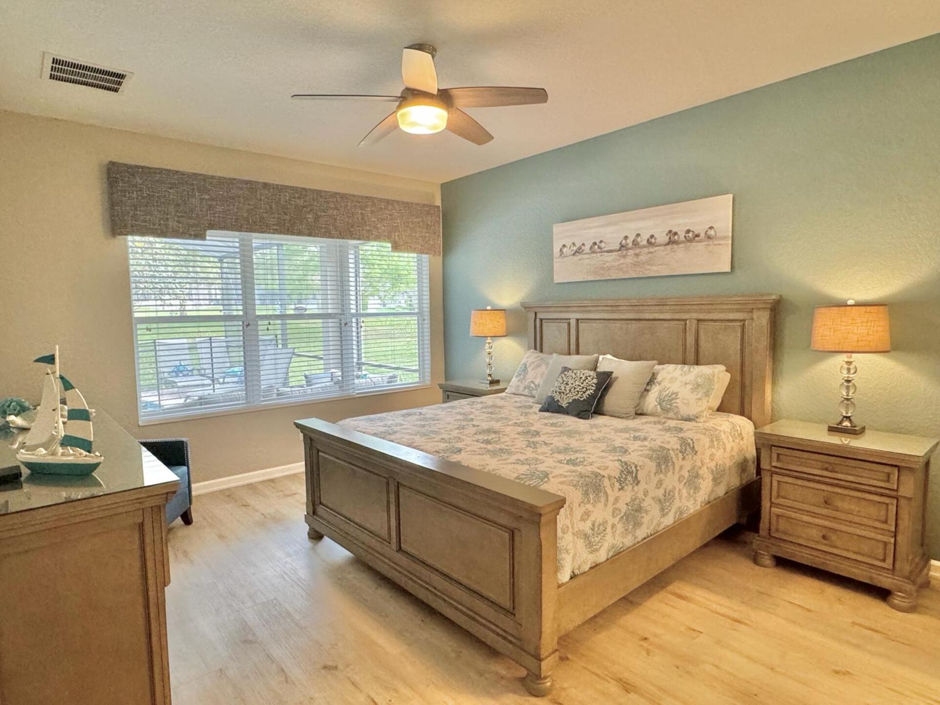 The first floor master suite features a King bed and views of the private pool