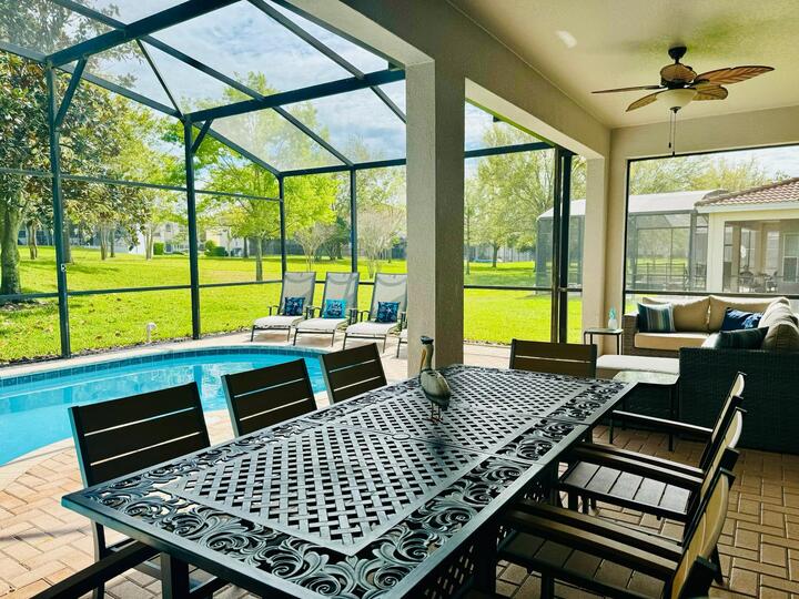 Dine al fresco underneath the covered lanai with seating for 8 and two ceiling fans for those hot summer days