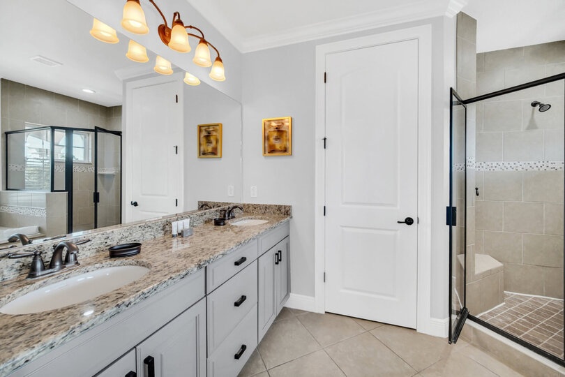 Upstairs main master bathroom with two sinks, garden tub walk-in shower