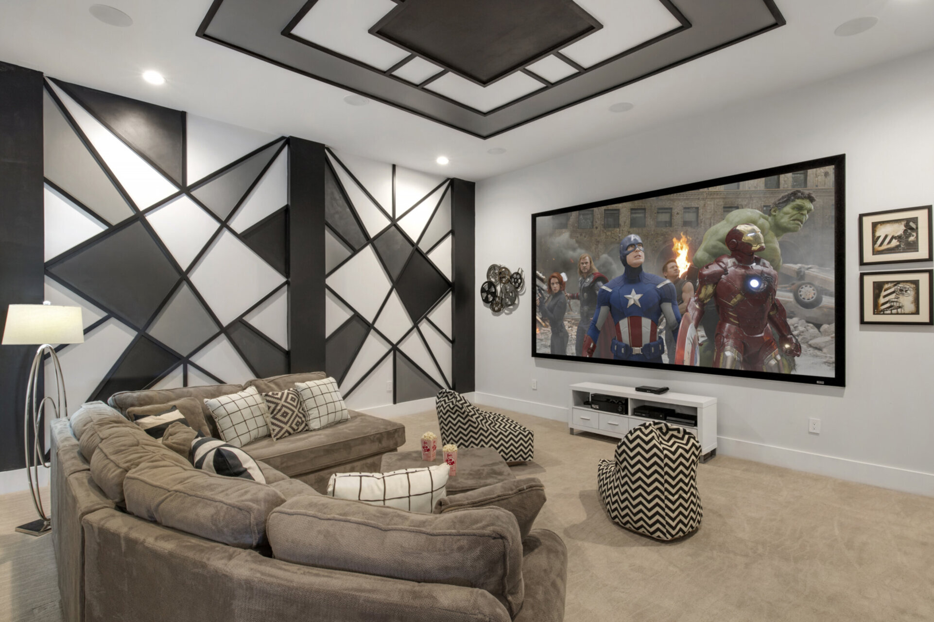 Modern meets retro in this theater room with a large projection screen