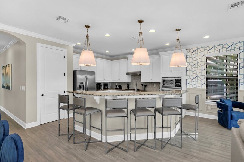 Fully equipped kitchen with stainless steel appliances and breakfast bar with seating for 6