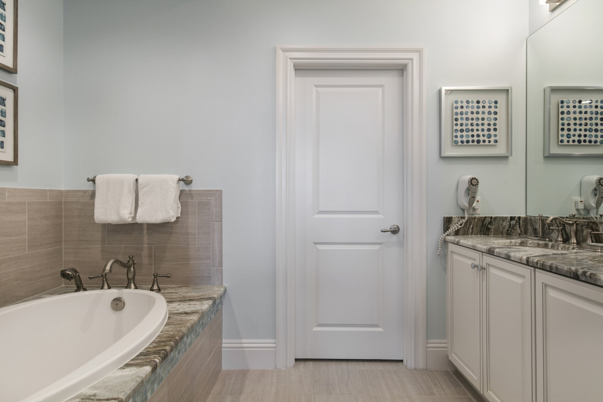 Master en-suite bathroom with glass walk-in shower, tub and dual vanity