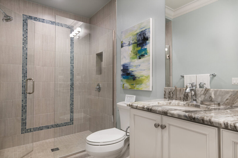 En-suite master bathroom with glass walk-in shower and dual vanity