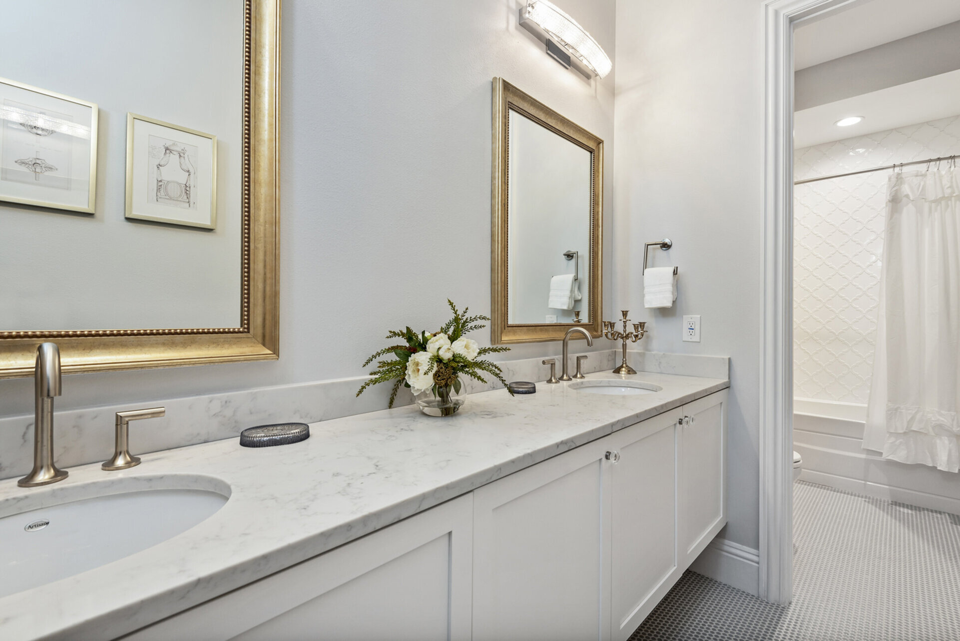 The connected bathroom has a dual vanity