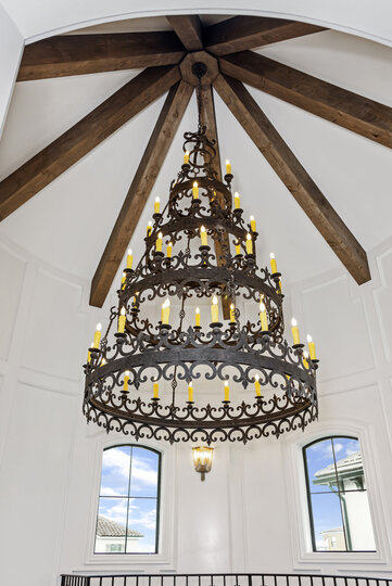 The custom Renaissance-inspired chandelier hangs beautifully from the 35-foot high celling