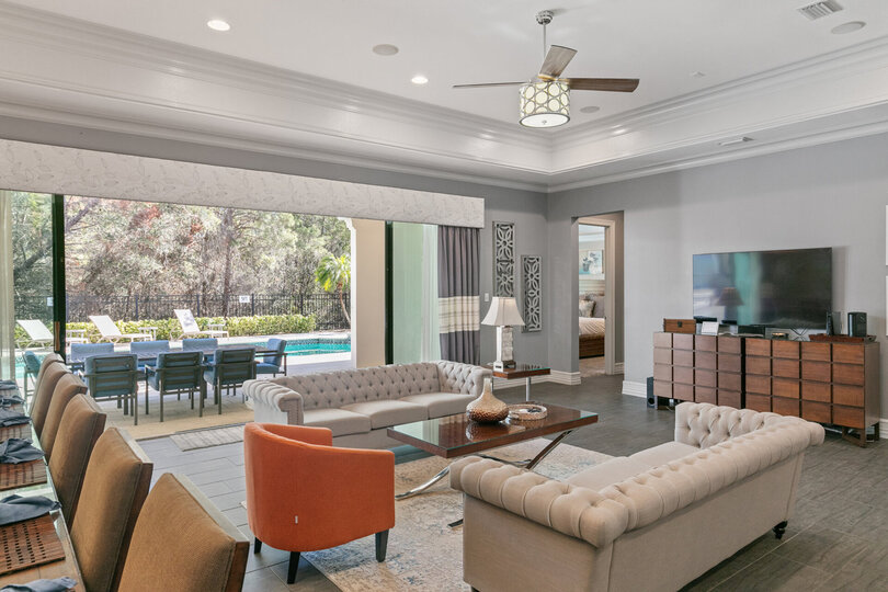 The living area features a 60-inch TV and ample seating