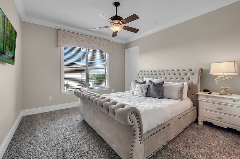 Relax and fall asleep to a favorite show in this cozy bedroom