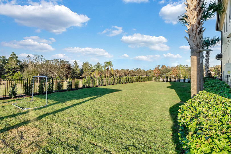 The home features a beautiful green space to play games outdoors