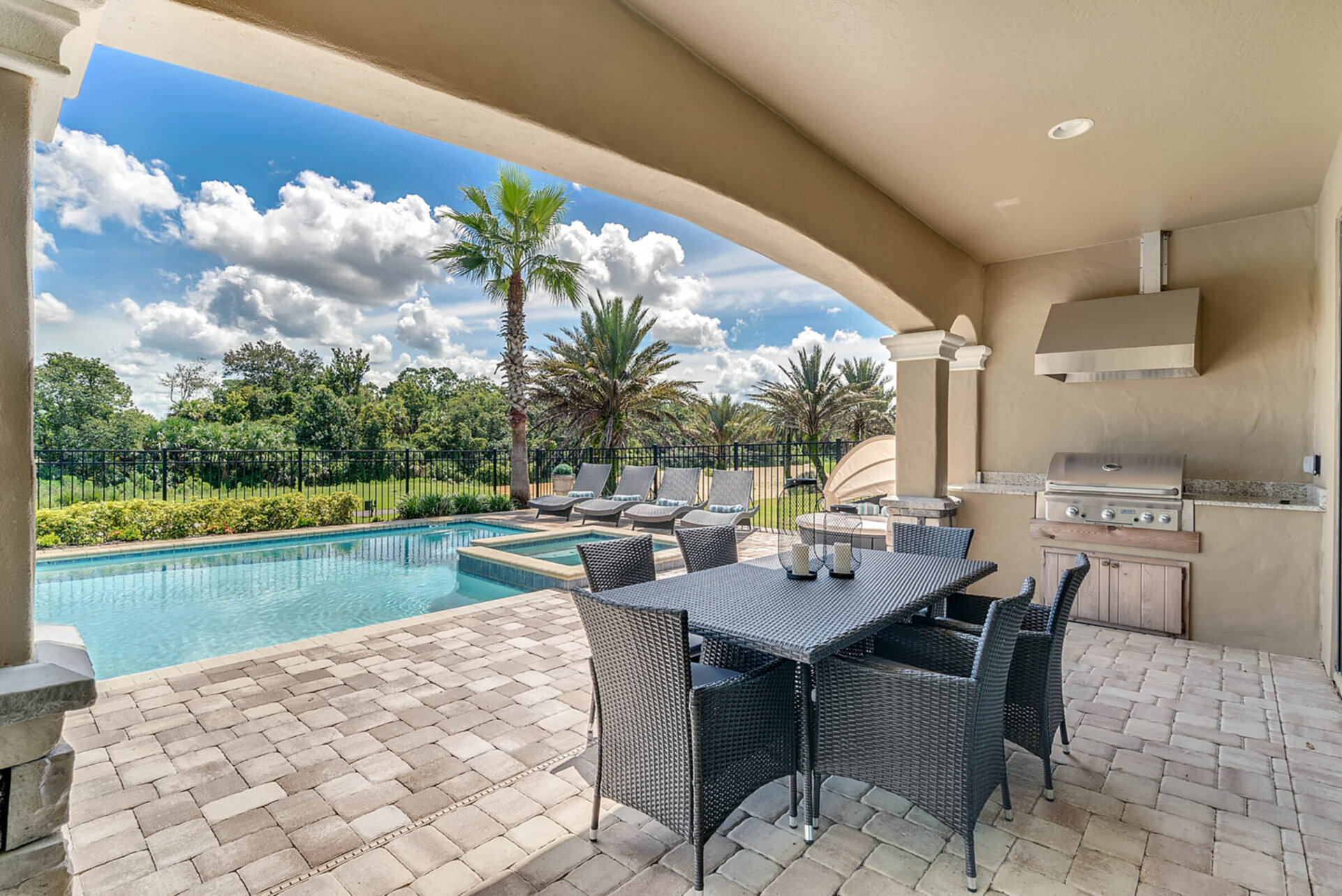 The home features a summer kitchen and outdoor dining table for 6 to enjoy a meal al fresco