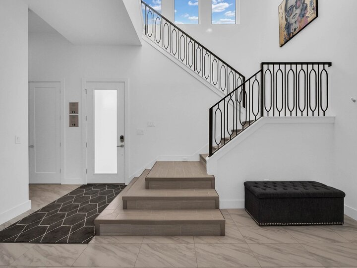 The stairs are located right by the entrance of the home