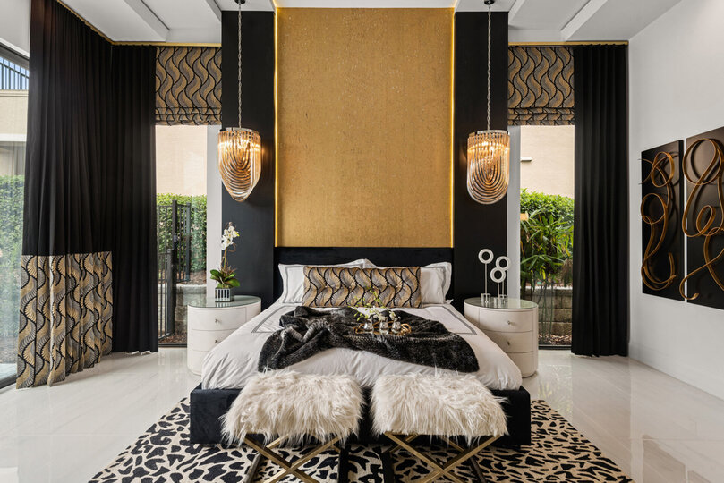 The ground floor Grand Master Suite is furnished with a king-size bed