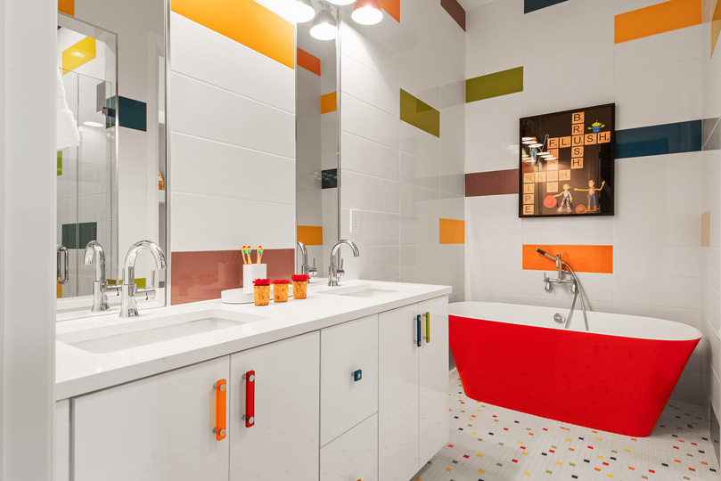 Bathroom with standalone tub connected to kids room