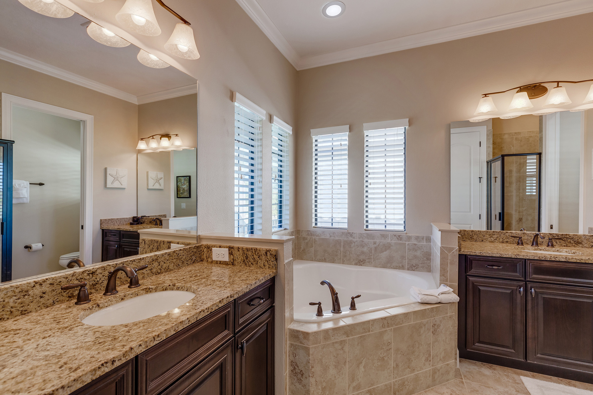 The master bathroom has double sinks and a relaxing bath tub