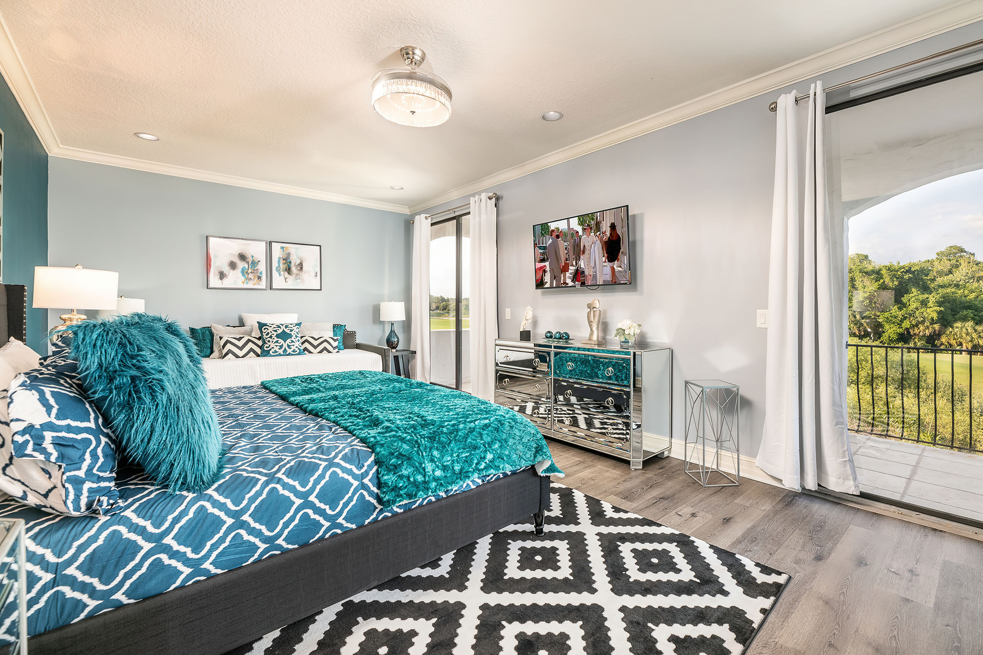 This second-floor master suite with a king-sized bed offers a private balcony with golf course views