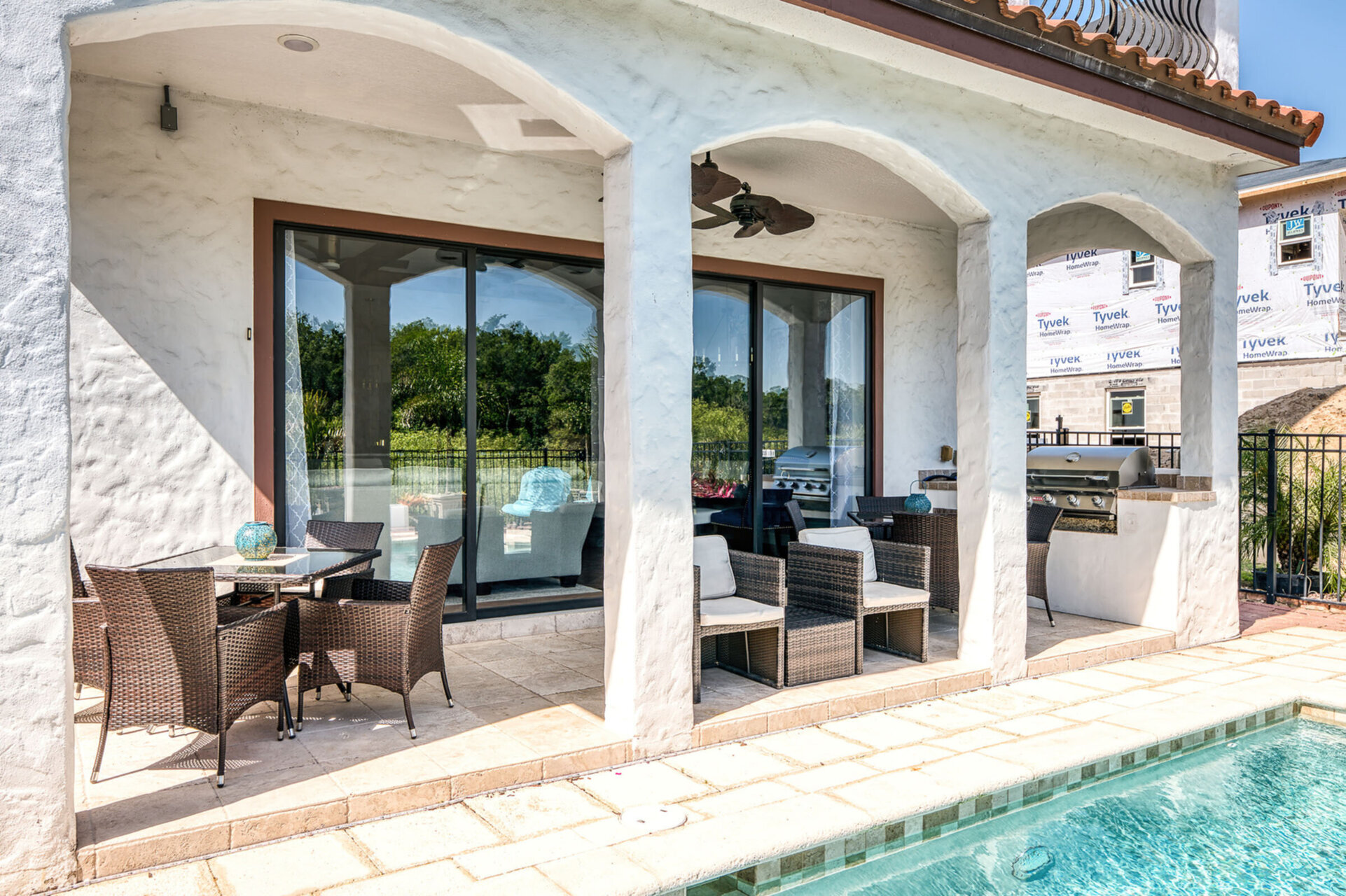 Cook outside in the summer kitchen with BBQ grill and dine al fresco at one of the 2 patio tables, each seating 4