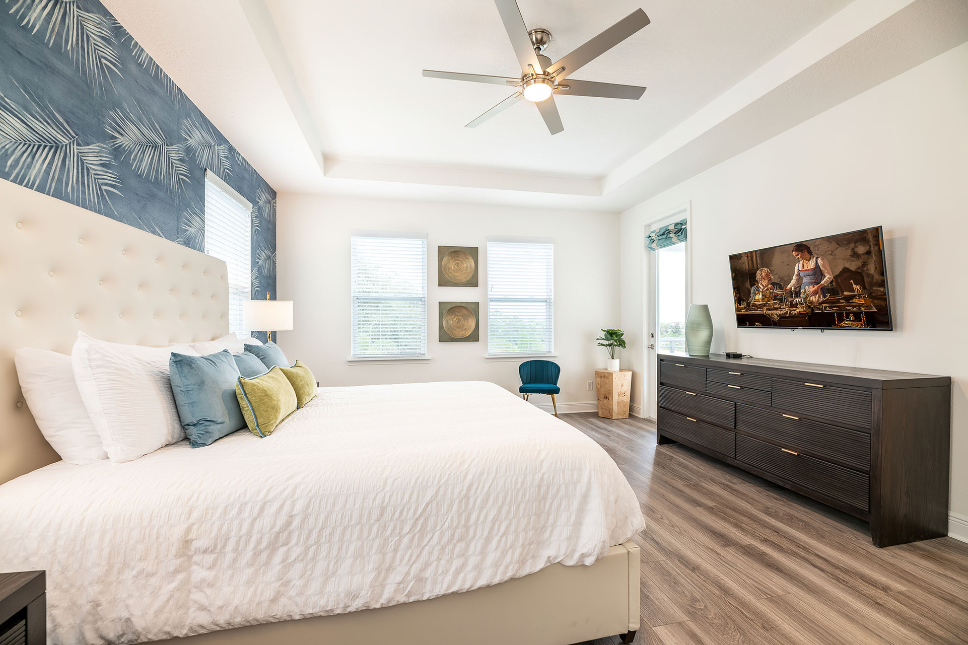 This second-floor master suite has a private balcony overlooking the pool and golf course
