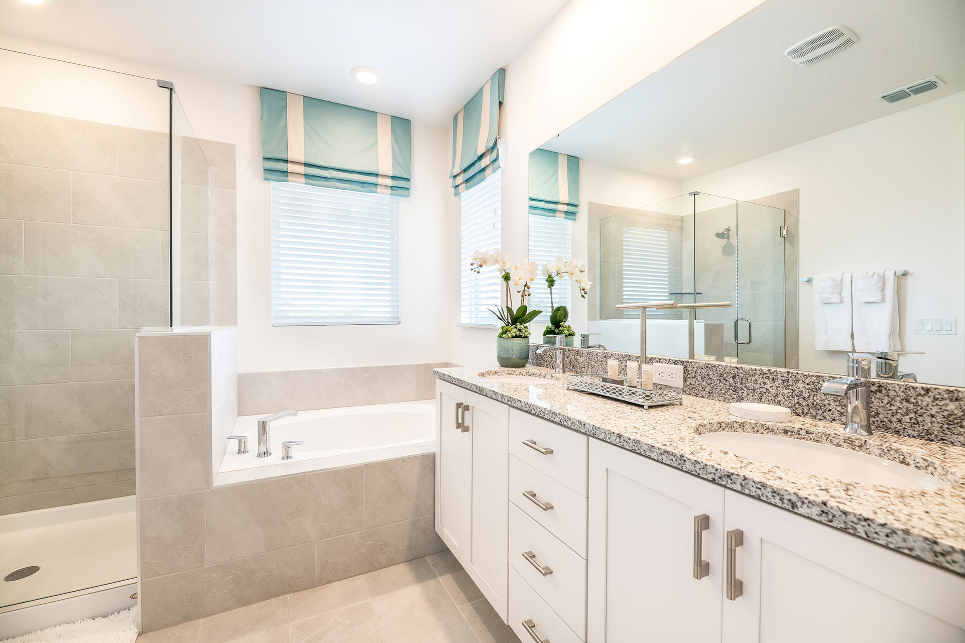 The upstairs master suite offers an en suite bathroom with a shower and a separate garden tub