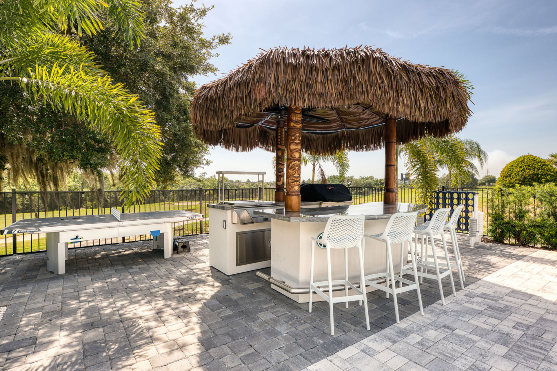 Enjoy a friendly game of ping pong under the shade of the palm tree