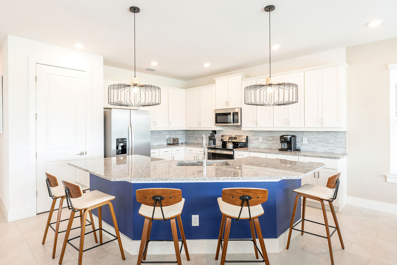 Cook a savory dinner for the family in the fully equipped kitchen with stainless steel appliances and granite countertops