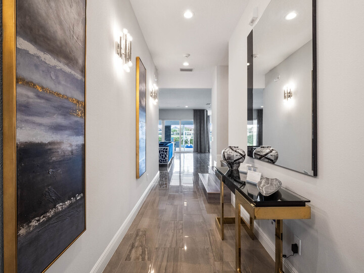 Adorned with exquisite paintings and a grand mirror, it's a corridor of elegance leading to the pool area.