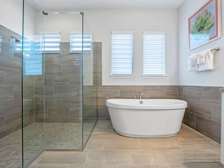 Indulge in luxury with our spacious bathroom featuring both a sleek walk-in shower and a relaxing bathtub.