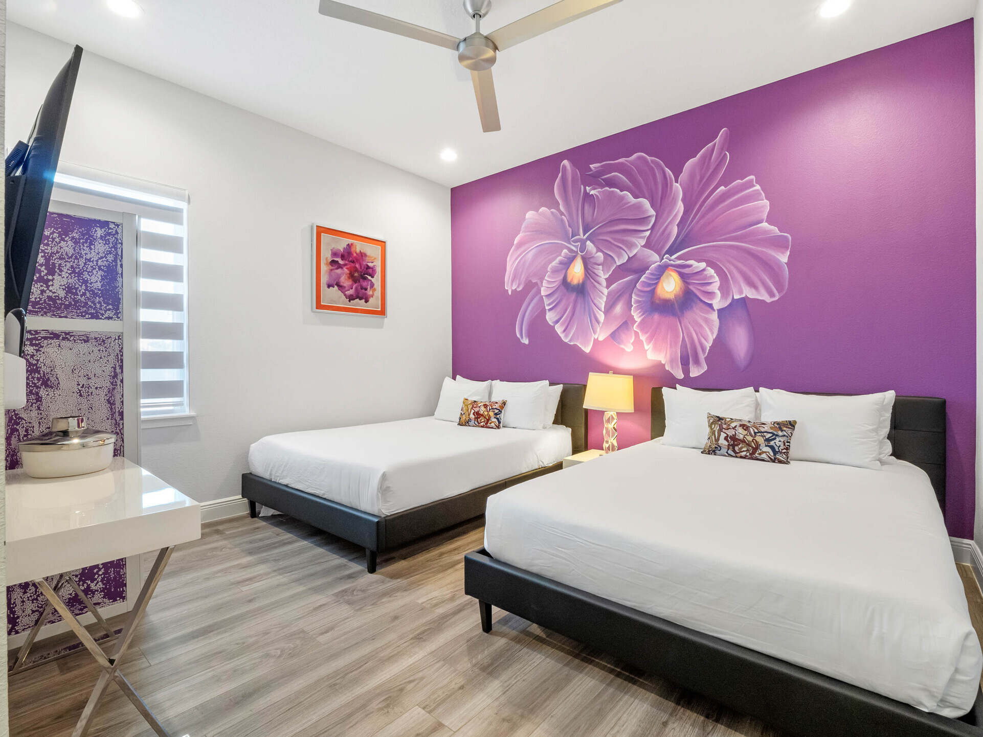 Discover a dreamy escape in our bedroom adorned in a calming shade of purple, complemented by the enchanting presence of a beautiful flower painting.