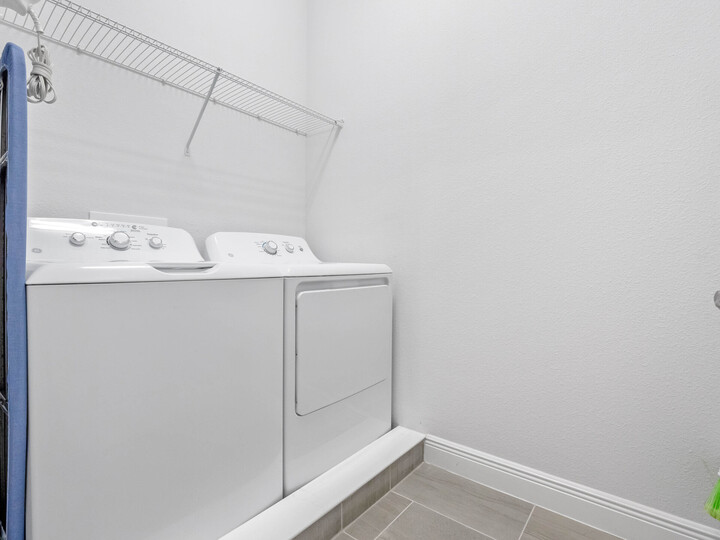 For your convenience, the laundry room is equipped with a top-load washer and dryer, making it easy to keep your clothes clean and fresh during your stay.