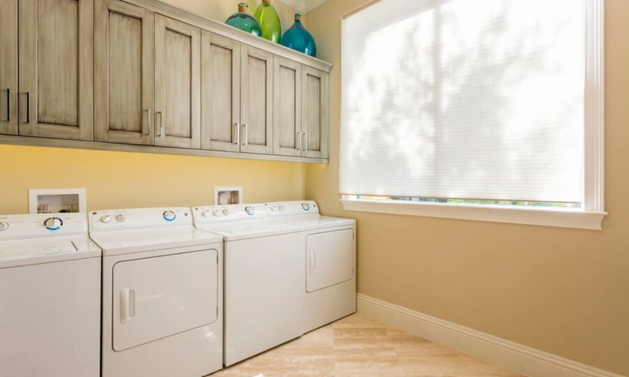 The ground floor laundry room has 2 sets of washers and dryers
