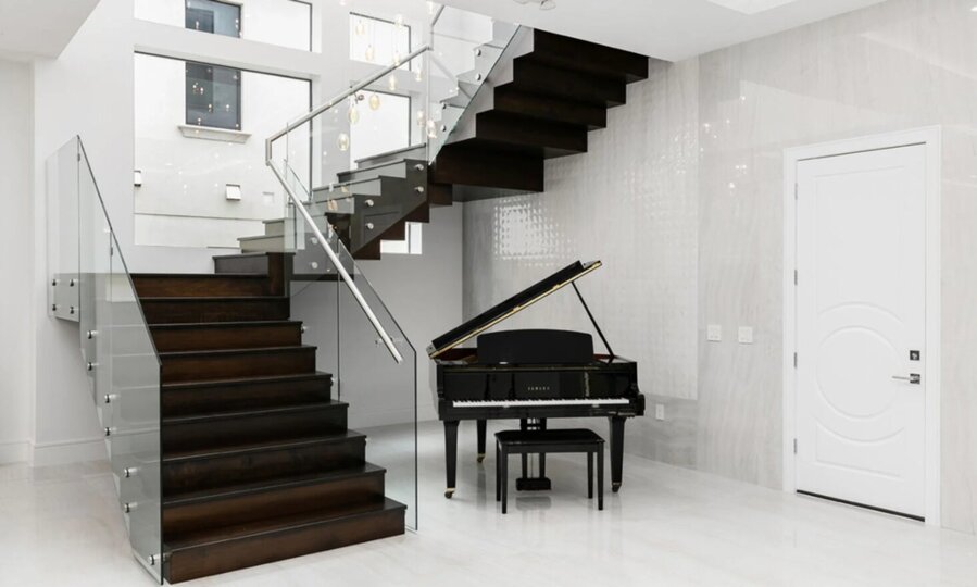 Yamaha Piano Beneath Modern Staircase