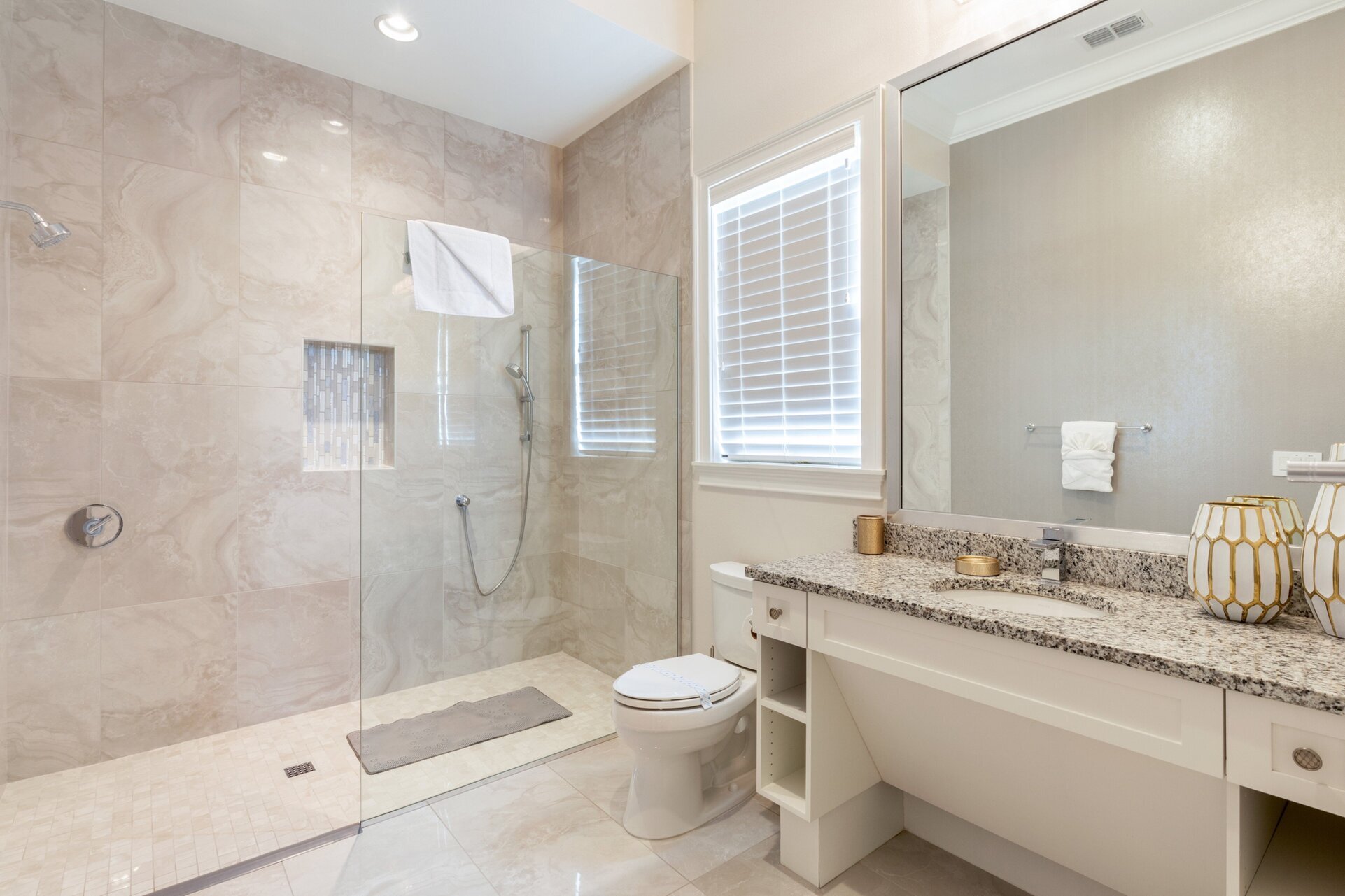 Refresh yourself in the modern shower area, featuring sleek fixtures and ample space for a rejuvenating experience