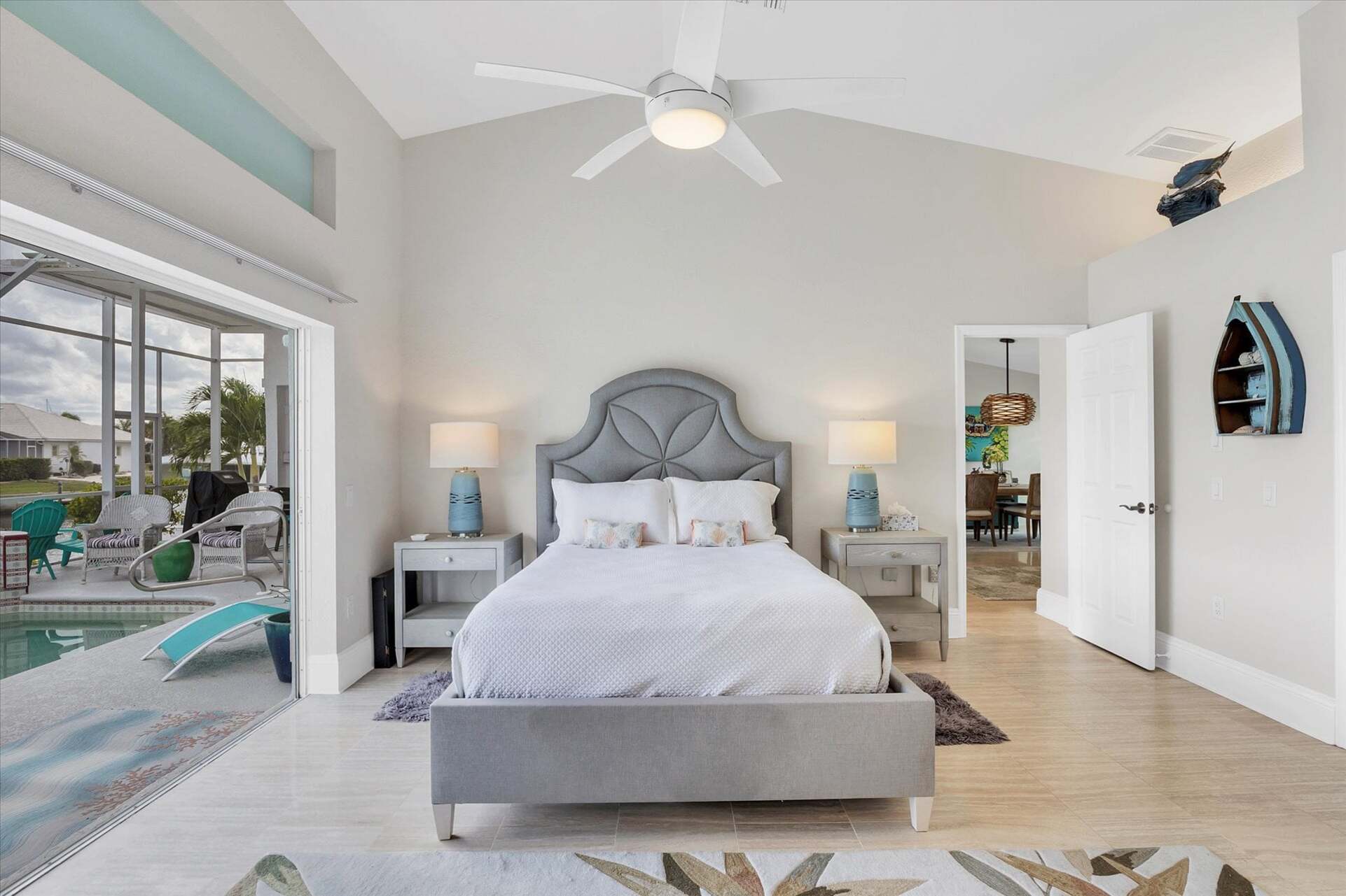 Primary bedroom with gorgeous water view, queen bed, attached bathroom and lanai access