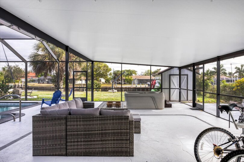 Extra large lanai overlooking the canal. Includes sparkling pool, relaxing hot tub, al fresco dining and more. Pool size: 14' x 28' x 6'