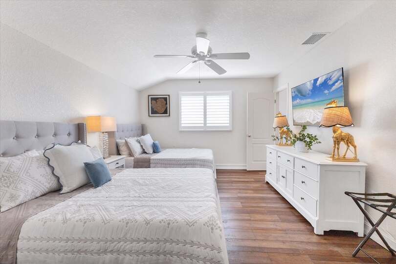 Upstairs Guest bedroom with two Full Beds and 43-inch Smart TV