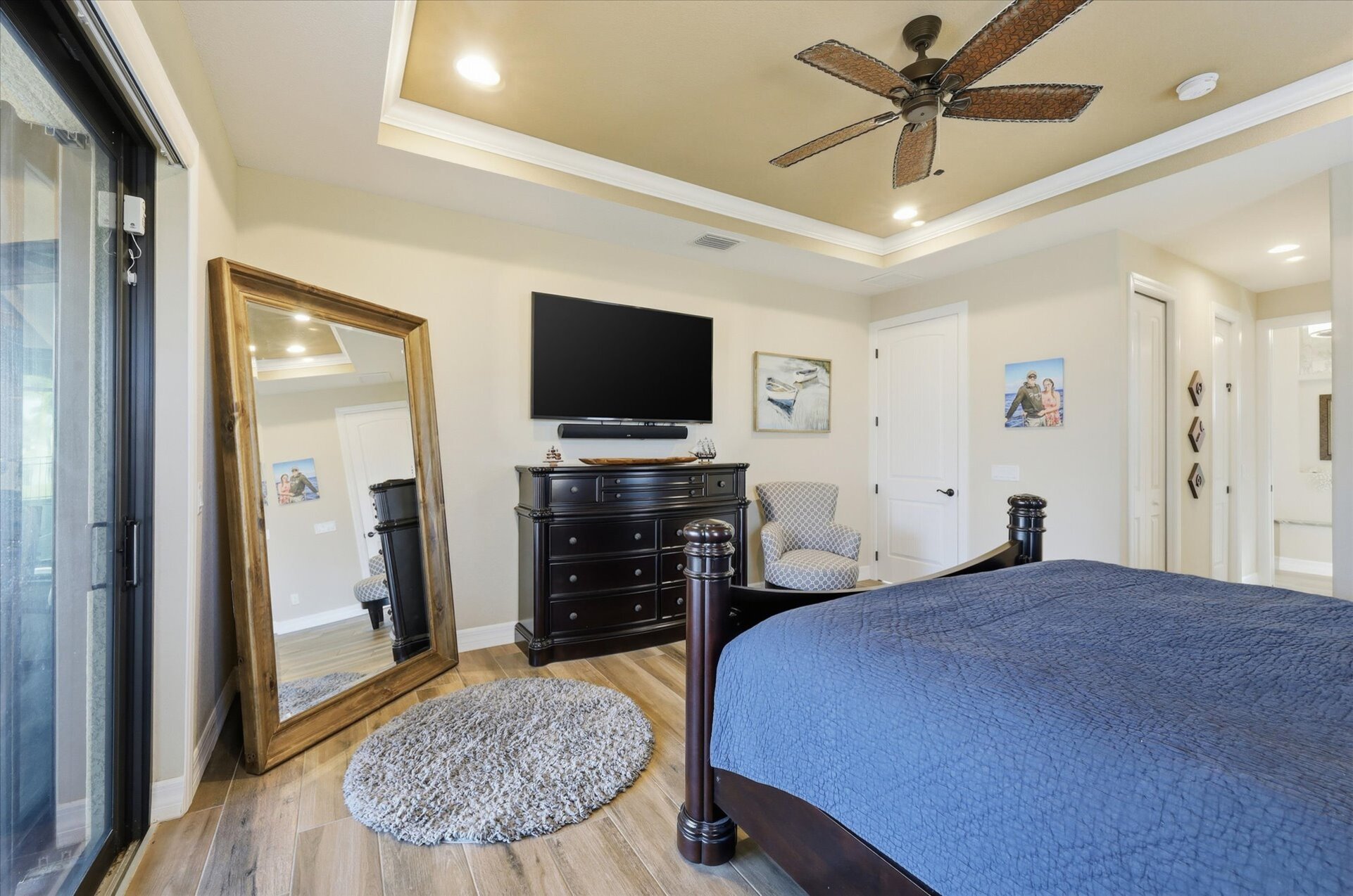 Primary bedroom with king bed, en suite, lanai accress, and 65-inch Smart TV