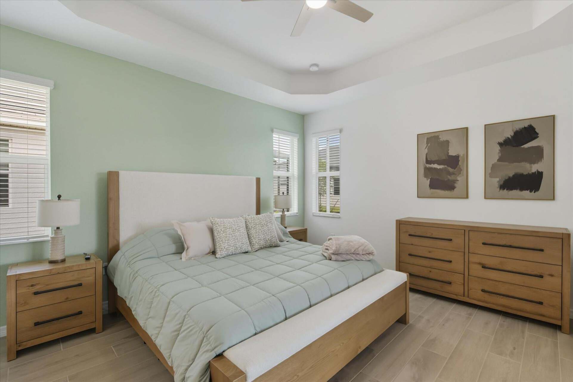 Primary bedroom with king bed, attached bathroom, lanai access, and 65-inch Smart TV