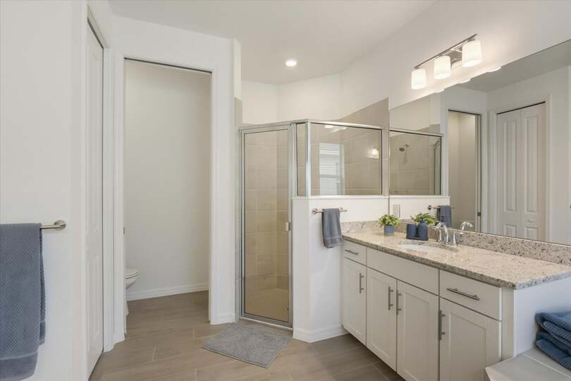 Primary attached bathroom with walk-in shower and garden tub