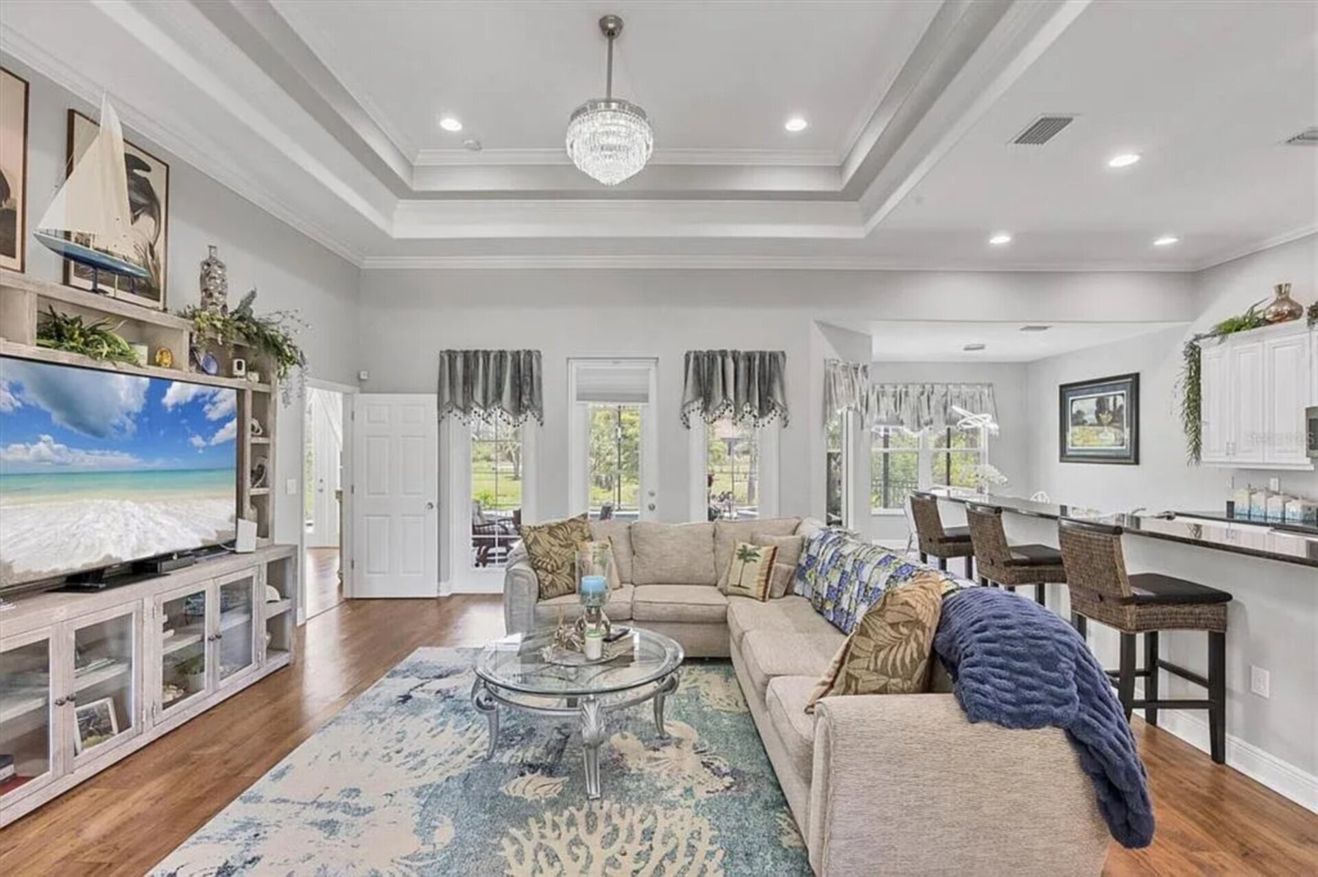 Beautiful open living space. Living room features lots of comfy seating and a 75" Smart TV
