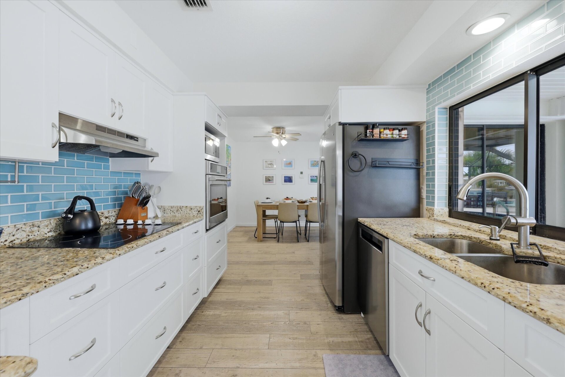 Bright, fully-equipped kitchen overlooking the pool and canal