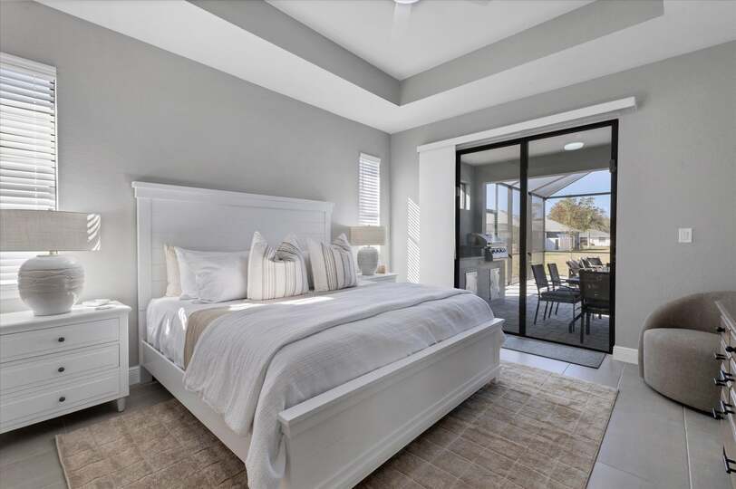 Primary bedroom with attached bathroom, lanai access, king bed and 43" Smart TV