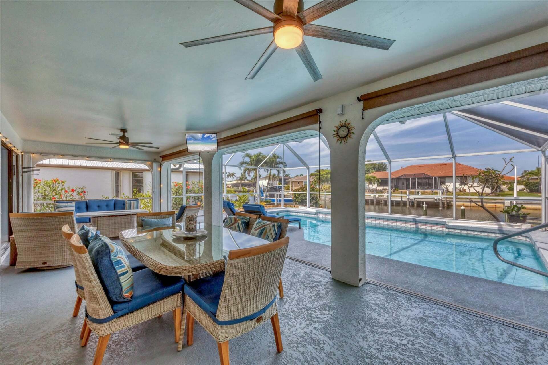 The Best of Florida Outdoor Living. Screened In Lanai overlooking the sparkling private pool and canal with 32" TV