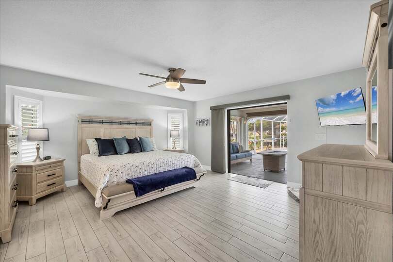 Primary bedroom with King bed, Lanai Access, en suite, and 42" Smart TV